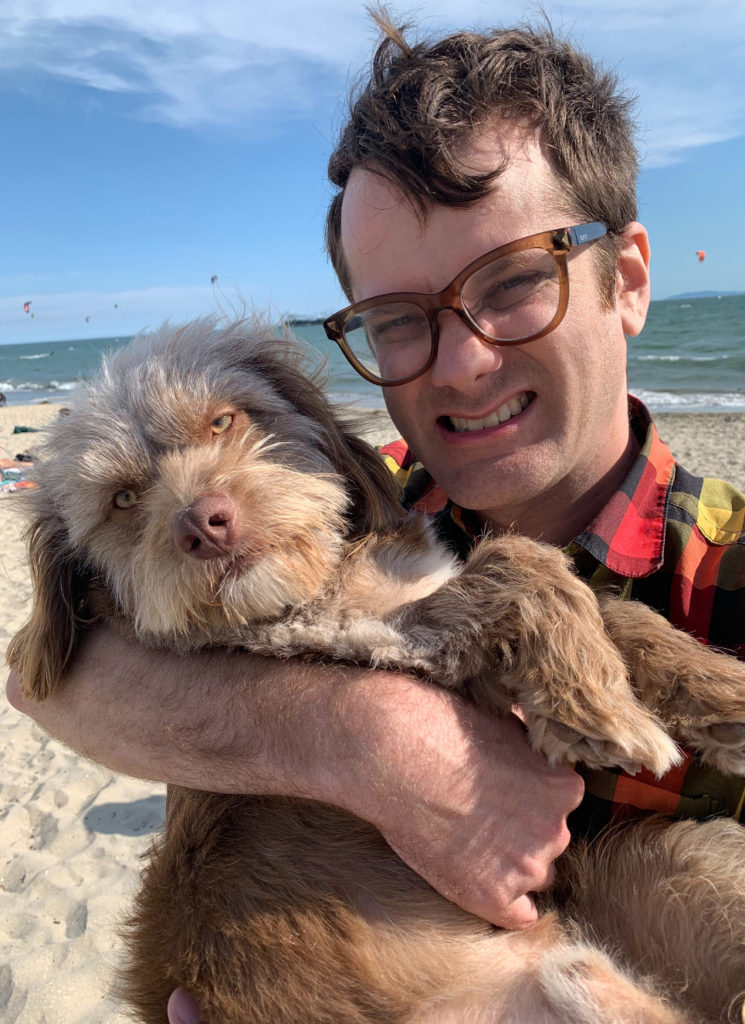 editor at beach with his cute dog